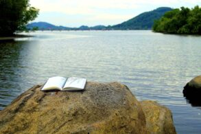 Writing notebook on rock next to river - From Confusion to Clarity: 3 More Stages on a Spiritual Path