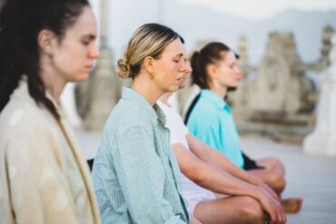 Small group of women meditating - How to Avoid the Subtle Pressure That Mindfulness Can Bring