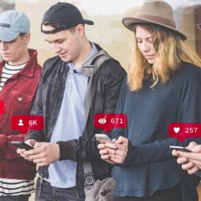 Four young people standing beside each other on cell phones - Common Unity: The Best Way to Find It in the Age of AI