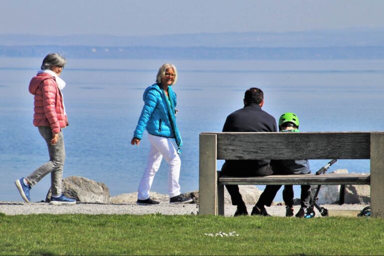 RECLAIM YOUR TIME THROUGH PRESENCE: 5 research-backed ways to do so 13 Two senior women, a man and a child spending time outdoors - Get Creative—And More—To Reclaim the Present Moment