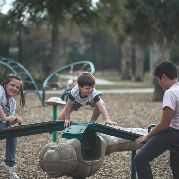 Three kids playing on playground equipment - How Social and Emotional Learning Helps Kids Succeed