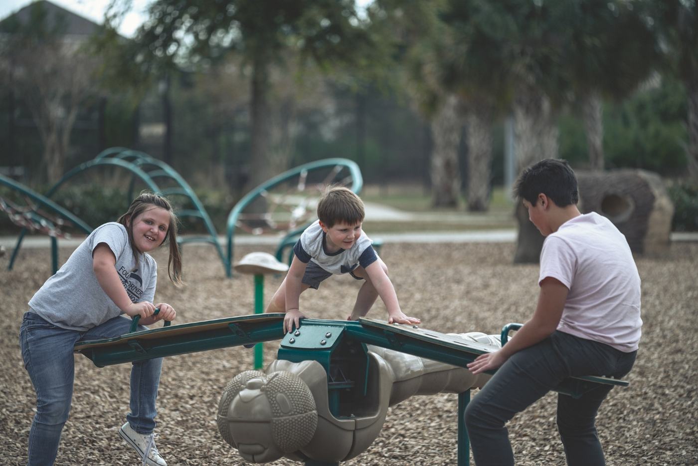 SOCIAL AND EMOTIONAL LEARNING: How teaching youth about emotional intelligence promotes happiness and success 13 Three kids playing on playground equipment - How Social and Emotional Learning Helps Kids Succeed