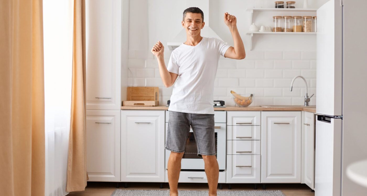 Young man dancing silly in kitchen - Where Happiness Begins: Calm Yourself in 15 Minutes or Less