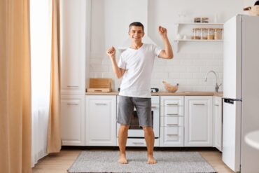 Young man dancing silly in kitchen - Where Happiness Begins: Calm Yourself in 15 Minutes or Less