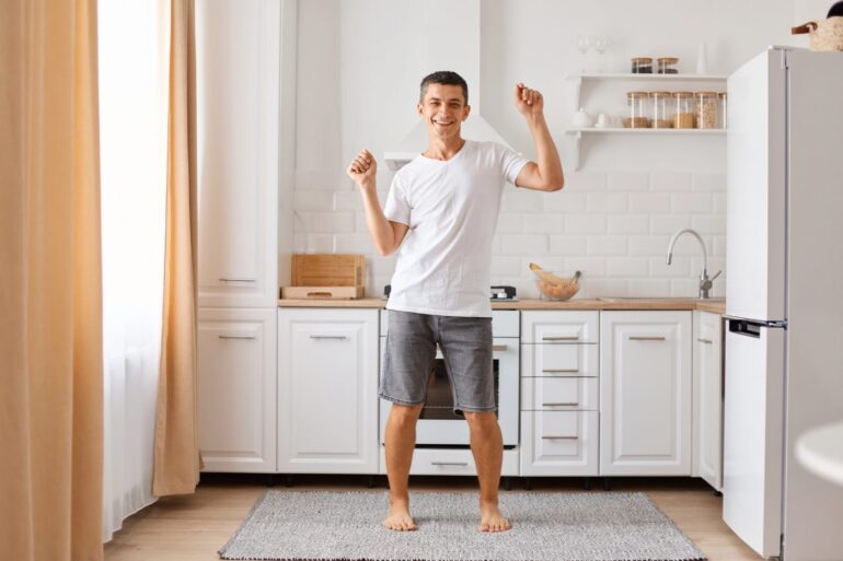 Young man dancing silly in kitchen - Where Happiness Begins: Calm Yourself in 15 Minutes or Less