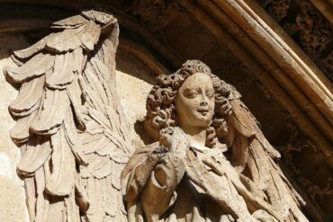 Stone angel over entrance of Llotja de Palma - Angelic Imagery: A Jungian Perspective