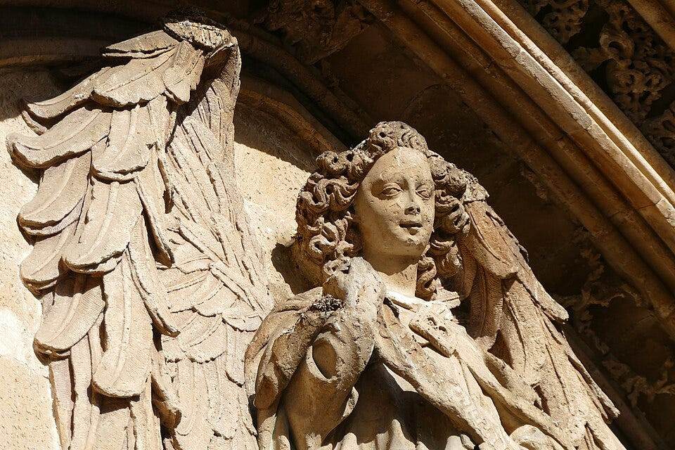 ANGELS AS NAVIGATORS OF MEANING: A Jungian perspective on symbols and the Inner Guide 13 Stone angel over entrance of Llotja de Palma - Angelic Imagery: A Jungian Perspective