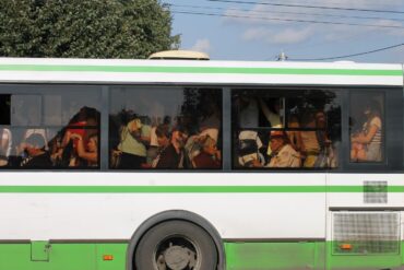 Outside view of public bus crowded with riders - Renunciation: How the 4 Noble Truths Can Help You Practice
