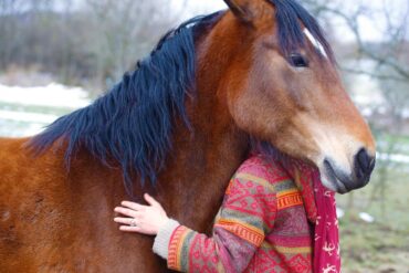 Woman hugging brown horse - How My Neurodivergence Led to New Empathy Towards Horses