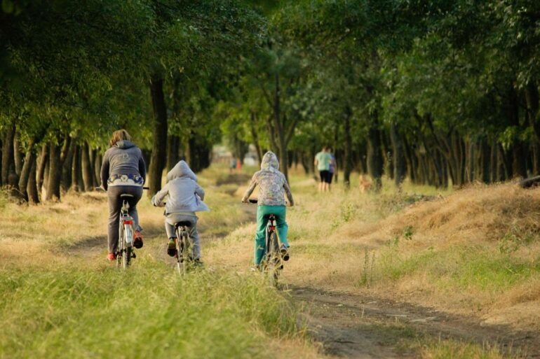 THE MISSING PIECE OF SELF-CARE: Without self-compassion, it won't last 13 People outdoors biking and hiking on trail - How Self-Compassion’s 3 Core Parts Lead to Lasting Wellness
