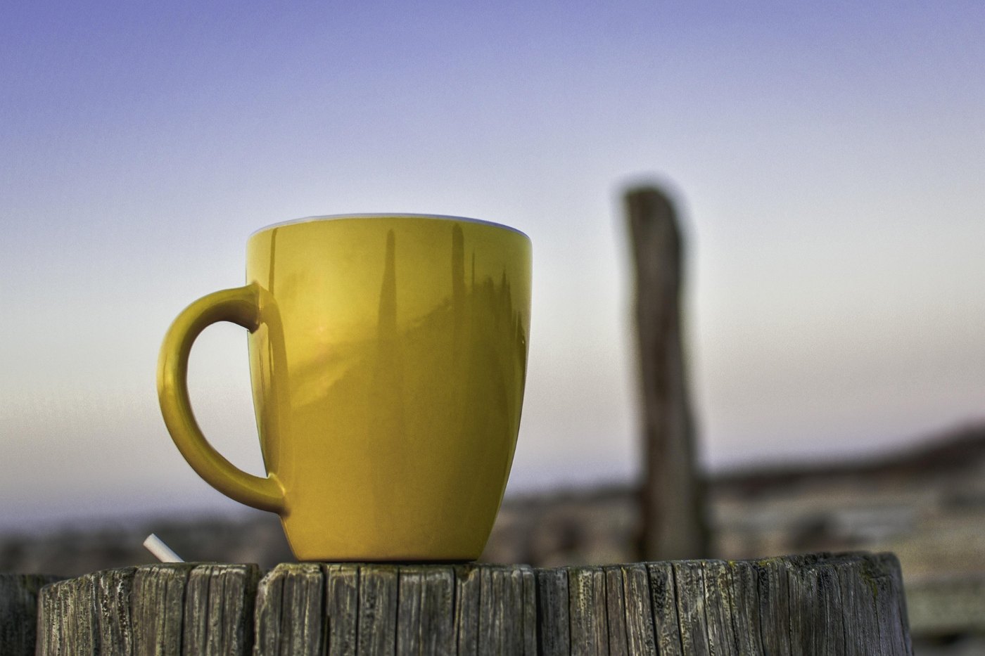 LEARN TO NOTICE THE SMALL THINGS: How gratitude changes the way we see ordinary days 13 Cup of tea on fence outdoors with blue sky in background - Gratitude for Ordinary Life: Find Beauty in Everyday Moments