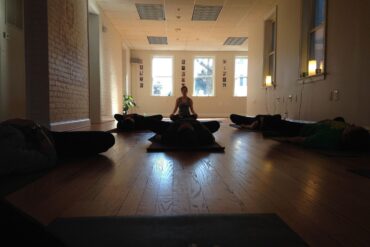 Students lying on floor on Yoga mats - Small Steps Will Quietly Lead You to the Summit of Meditation