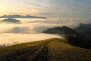 Two people seen at a distance walking towards misty mountains - Why I Decided to Stop Making Myself Smaller in Relationships