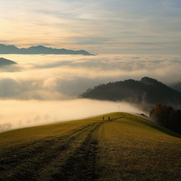 Two people seen at a distance walking towards misty mountains - Why I Decided to Stop Making Myself Smaller in Relationships