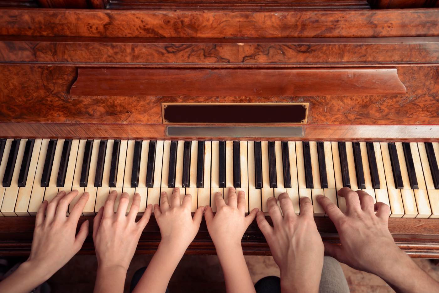 WHAT THE PIANO TAUGHT ME: 3 life lessons learned during my first few months of practice 14 Three sets of hands playing the same piano - Your Piano Is Patiently Waiting for You—Go Play!