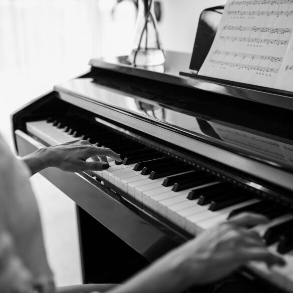 Black and white image of woman playing piano - Your Piano Is Patiently Waiting for You—Go Play!