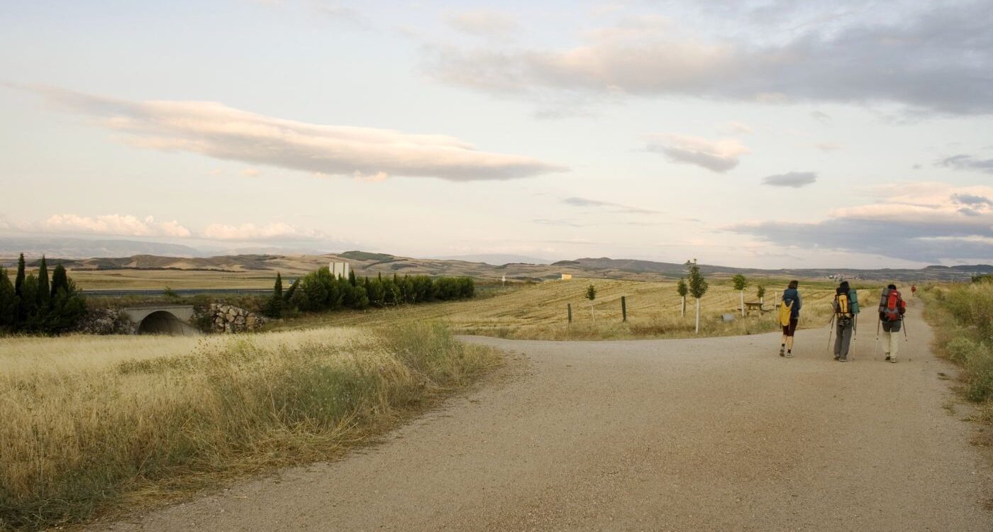 Three people walking down the Way of St. James trail - Life’s Pilgrimage: Journeying Towards Our Spiritual Home