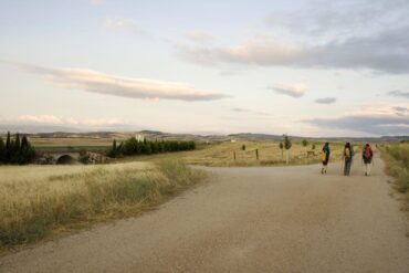 Three people walking down the Way of St. James trail - Life’s Pilgrimage: Journeying Towards Our Spiritual Home