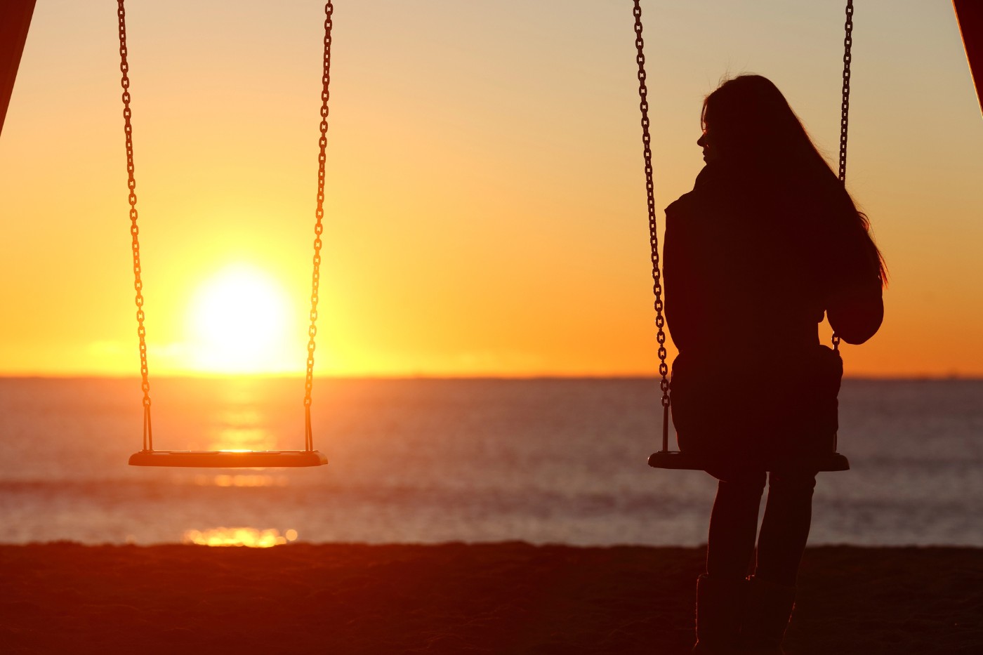 FIND PEACE AFTER LOSS: How a sense of connection can help with grief 15 Woman on swing with empty swing beside her - A Quiet Sense of Connection Can Lead You to Peace After Loss