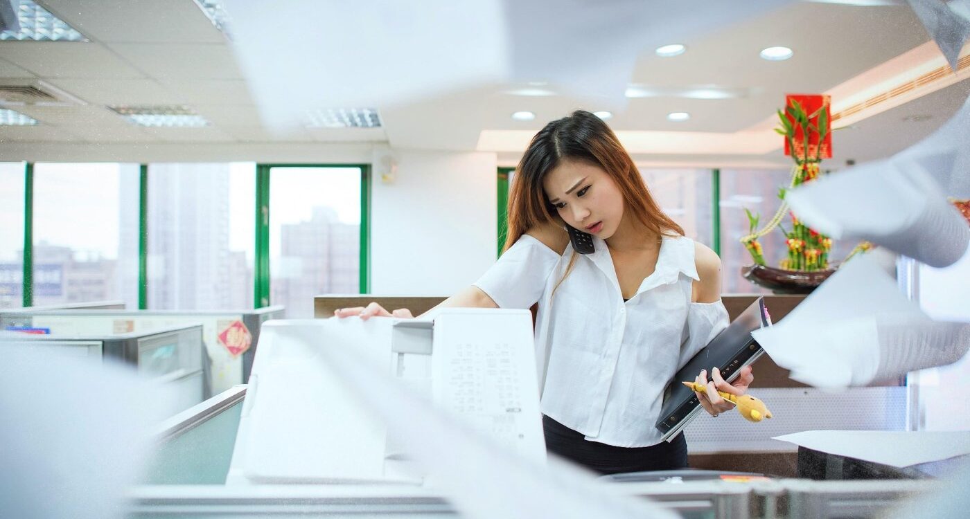 Stressed-out young woman answering phone in office - Stopping Pressure From the Outside World Before It Sets In