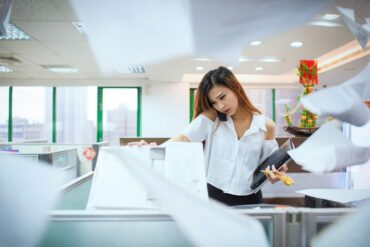 Stressed-out young woman answering phone in office - Stopping Pressure From the Outside World Before It Sets In