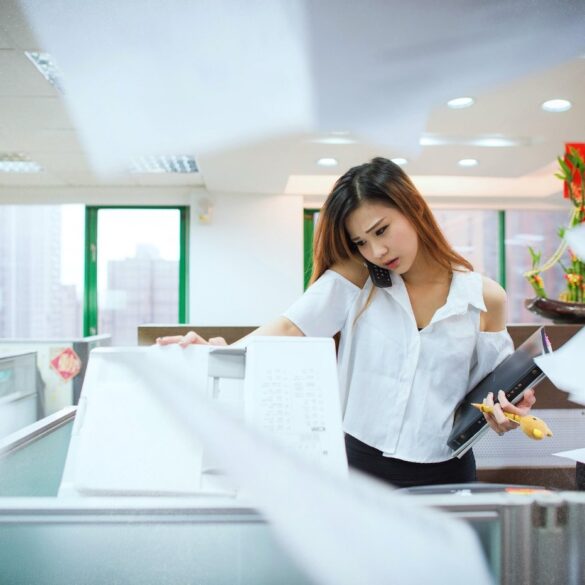 Stressed-out young woman answering phone in office - Stopping Pressure From the Outside World Before It Sets In