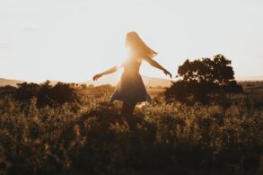 Young woman running freely through field - 3 Anchors to Help You Avoid Your Ego’s Voice