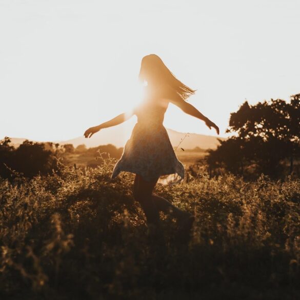 Young woman running freely through field - 3 Anchors to Help You Avoid Your Ego’s Voice