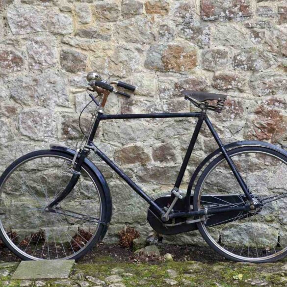Traditional bicycle parked outdoors against stone wall - "Creepy Creatures" and 4 More New Poems About Life’s Seasons