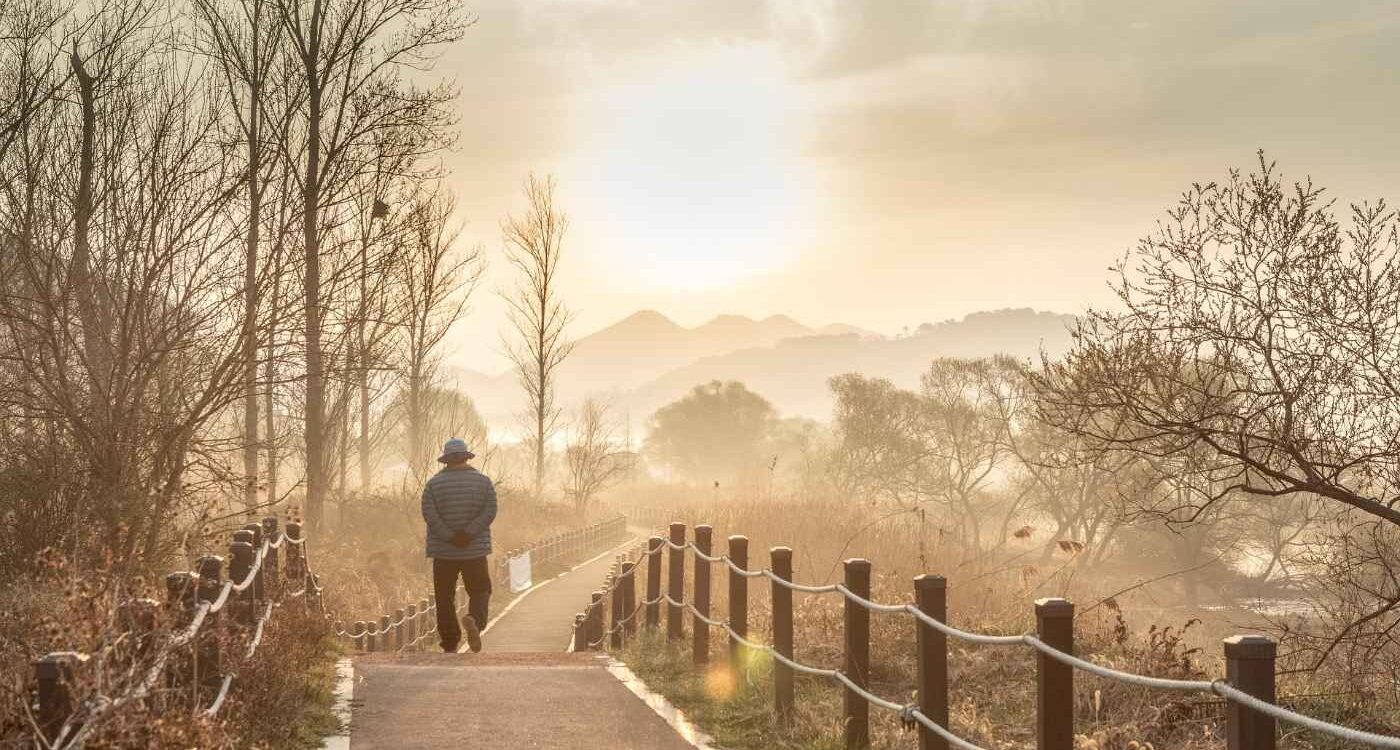 Senior man walking across bridge - An Internal Locus of Control: The Road to Lasting Happiness