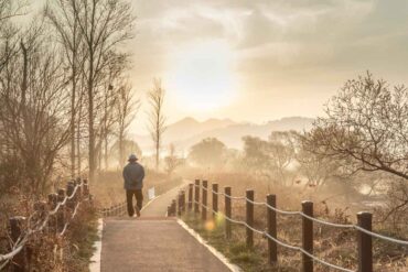 Senior man walking across bridge - An Internal Locus of Control: The Road to Lasting Happiness