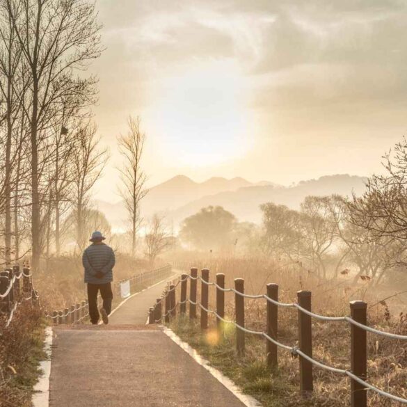 Senior man walking across bridge - An Internal Locus of Control: The Road to Lasting Happiness